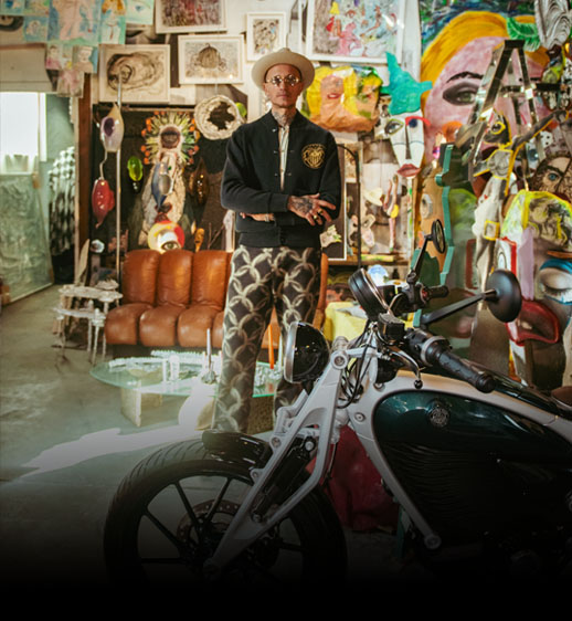 Featured story banner showing Flying Flea electric motorcycle